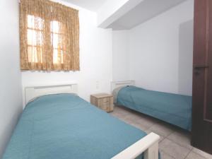 古瓦伊Flower Apartments的一间卧室设有两张床和窗户。