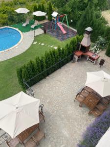 阿斯帕鲁霍沃Eco House Kitana的一个带滑梯的庭院和一个带遮阳伞的游乐场