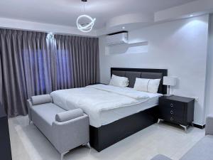 伊尔比德Saraya Al Joude的一间卧室配有一张大床和一把椅子