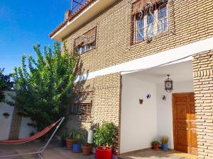 塞维利亚Preciosa casa grande con patio en Sevilla 8PAX的房屋前方设有吊床