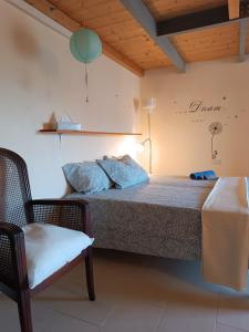 卢卡Casa Garibaldi的一间卧室,卧室内配有一张床和一把椅子