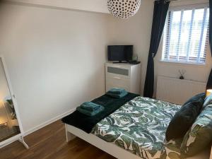 格拉斯哥Perfectly situated luxury 2 bedroom apartment的一间小卧室,配有一张床和电视