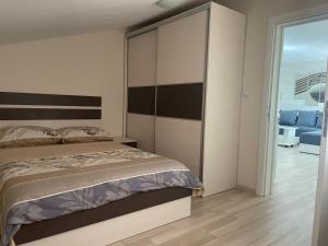 弗拉迪钦汉Apartmani Vrla的一间卧室配有一张带大床头板的床