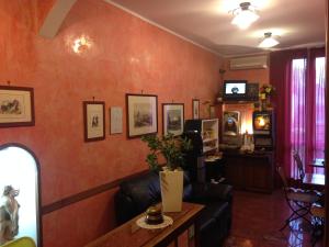 米兰肖邦酒店的客厅设有橙色墙壁和沙发