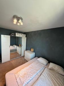 克里斯蒂安桑Koselig leilighet på Bystranden的一间卧室设有一张床和黑色的墙壁