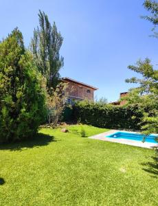 Las CompuertasCasa Huellas de Malbec - Montaña y paz的房屋前带游泳池的院子