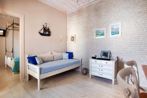 普拉塔尼亚斯阿尔基奥尼德斯海滨酒店的一间卧室配有床、梳妆台和砖墙