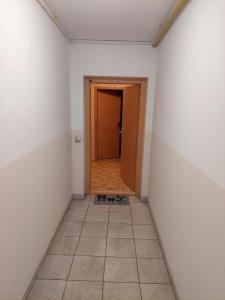 马里博尔Apartma Kaj in Kaja的一条空的走廊,有门,铺着瓷砖地板