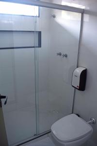 塞古罗港MIRAGE HOTEL的一间带卫生间和玻璃淋浴间的浴室