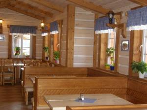 捷克布杰约维采赫尔斯基斯登波幅卡酒店的餐厅设有木长椅、桌子和窗户