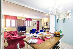 科孚镇Via Porta Raimonda (Luxury central detached house)的客厅配有桌子和红色沙发