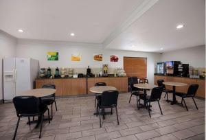 塔拉哈西Quality Inn Tallahassee near University的一间带桌椅的餐厅和一间厨房