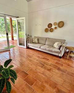 卡维塔Casa Martin Cahuita Charming Spanish Home的带沙发和木地板的客厅