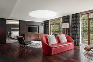 厦门厦门艾美酒店（位于城市公园之中，森林氧吧）的客厅配有红色椅子和电视
