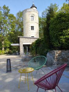 索米尔Chambres d'hôtes La Tour de Bellevue的灯塔前的一组椅子和一张桌子