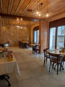 莱斯卡拉Taverna de la Sal Boutique Hotel的一间带桌椅的餐厅以及砖墙