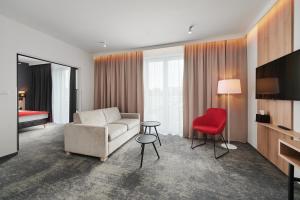 热舒夫Best Western Plus Hotel Rzeszow City Center的带沙发和红色椅子的客厅