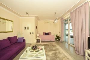 斯梅代雷沃Apartments Villa Graf的客厅配有紫色沙发和床。