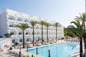 马贝拉Alanda Marbella Hotel的一张酒店的照片,里面设有游泳池和棕榈树