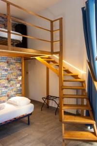 那不勒斯Sweet Sleep Studios的一间设有双层床和一张床的客房,以及楼梯