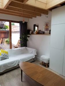 克莱蒙费朗Maison hypercentre calme, terrasse, garage, poêle的一间卧室配有一张床、一张桌子和一个窗户。