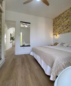 莫哈卡尔Apartamento PLAYA LAS VENTANICAS的白色卧室设有一张大床和镜子
