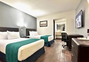 奥夫雷贡城InHouse Obregón的酒店客房配有两张床和一张书桌