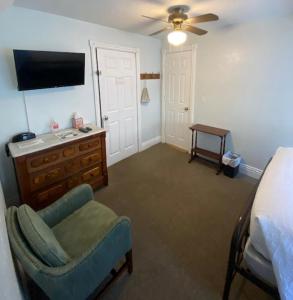 圣地亚哥切诺基洛奇住宿加早餐旅馆的一间卧室配有一张床、一把椅子和电视。