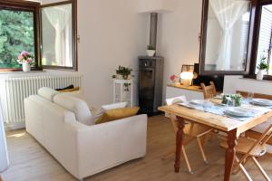Tenna Serenity Escapes - Caldonazzo Lake的客厅配有白色的沙发和桌子