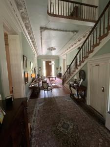 WaysideThe Belmont 1857的一间设有楼梯和客厅的大房间