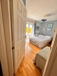 帕多克伍德One double bedroom with en suite in Paddock Wood的一间卧室设有两张床和一扇开放式门