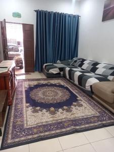 话毛生D'tasek Homestay Gua Musang的客厅配有两张床和地毯。
