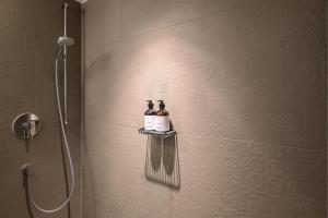 慕尼黑HApato的浴室的架子上装有两瓶葡萄酒的淋浴