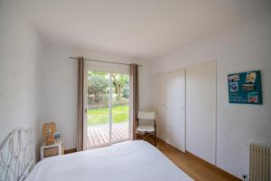 阿卡雄Villa de 4 chambres a Arcachon a 650 m de la plage avec jardin et wifi的一间卧室设有一张床和一个大窗户