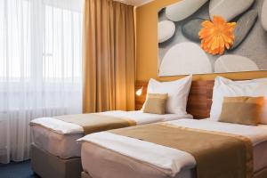 布尔诺维史塔酒店的酒店客房设有两张床,墙上挂有绘画作品