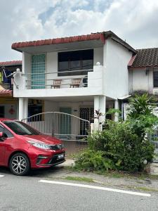 亚依淡AAA Homestay Georgetown Penang的停在房子前面的红色汽车