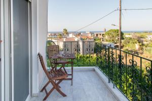 RopanianáSearenity Home的设有一个配有桌椅并享有美景的阳台。