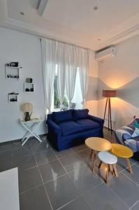 Dar Mimoun BeyLa Maisonnette Turquoise的客厅配有蓝色的沙发和桌子