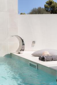拉夫蒂港White Cliff Luxury Suites by A&D Properties的一间卧室,卧室旁边设有游泳池