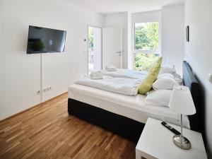 维也纳MySchönbrunn Apartments的卧室配有一张床铺,墙上配有电视