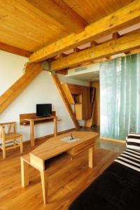 ŽabičiūnaiVasaknų dvaras的带沙发和木制天花板的客厅