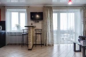 尼古拉耶夫Студия и отдельная спальня в Центре的客厅配有椅子和墙上的电视
