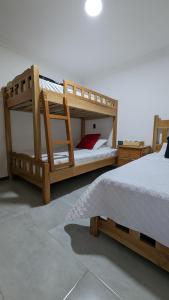 圣罗莎德卡瓦尔Apto lujo con jacuzzi y parqueadero piso 4的配有两张木制双层床的客房
