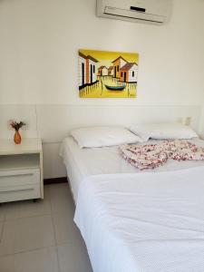 Entre RiosApartamento Particular de 03 suítes, Resort Treebies, Praia de Subauma - Ba的一间卧室设有两张床,墙上挂着一幅画