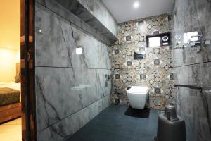 纳威孟买MEGH INN的一间带卫生间和石墙的浴室