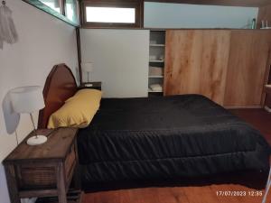 马德普拉塔Cabaña UMA - Rumi Huasi的一间小卧室,配有一张床和一张桌子