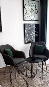 奥西耶克Studio Apartman Lucija的客厅配有两把椅子和一张桌子