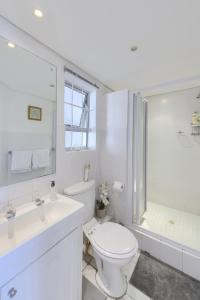 开普敦Loft Apartment off Kloof with Table Mountain views的白色的浴室设有卫生间和淋浴。