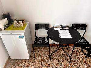 贝加莫Camere Giulia的一张黑桌子和两张椅子