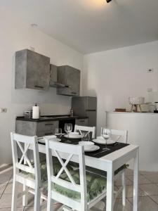 Albese Con CassanoJACAM home free parking的厨房配有白色的桌子和白色的椅子